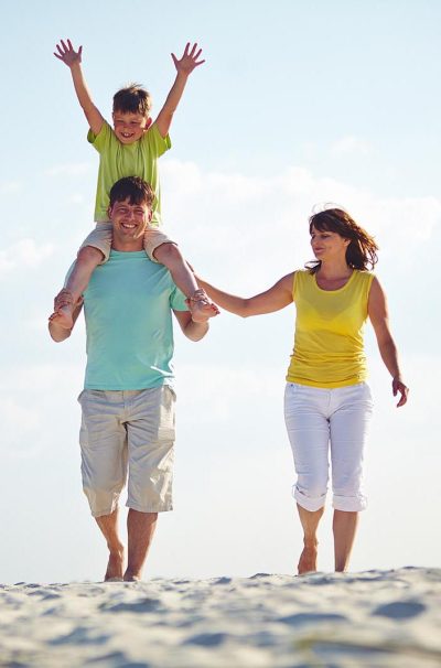 Happy family enjoying the time on the beach together